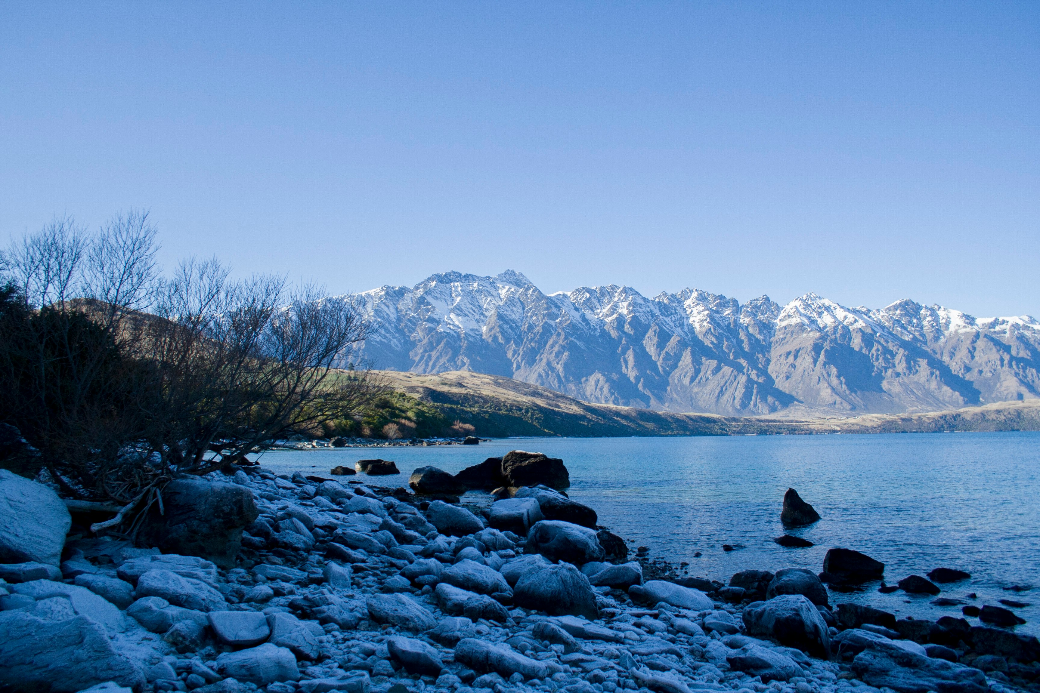 black and white mountains near body of water during daytime